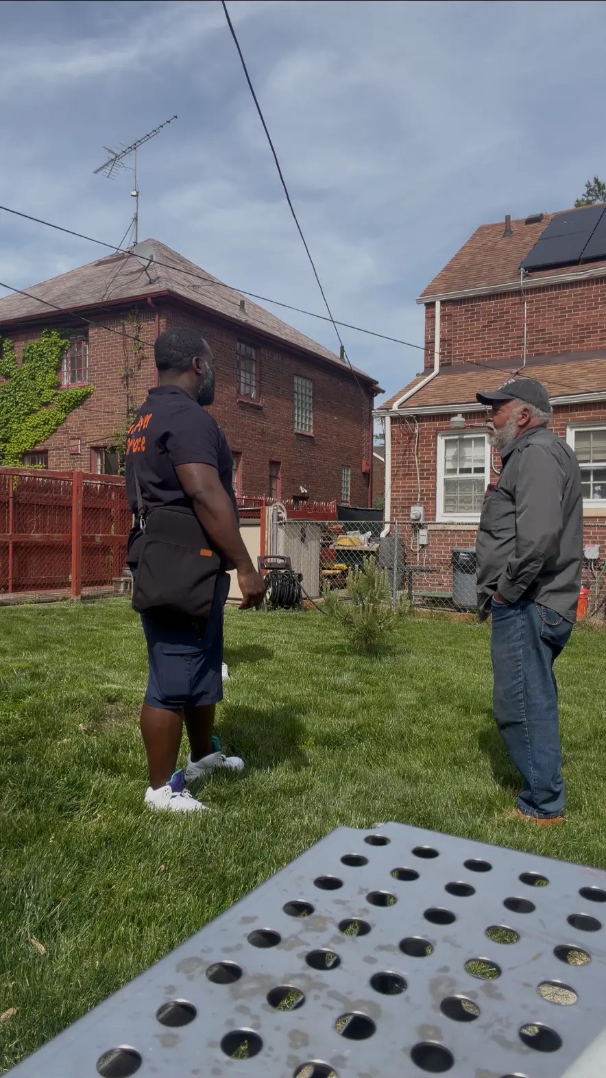 MIHSS team member speaking with a homeowner in his backyard