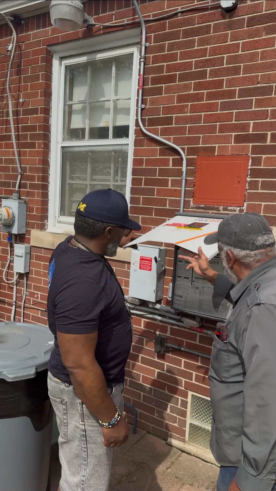 MIHSS specialist reviewing a home's electrical panel with the homeowner